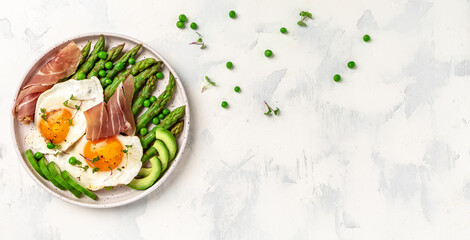 Grilled Toast witch Asparagus, Poached egg, bacon jamon, ham, prosciutto on white background. Long...