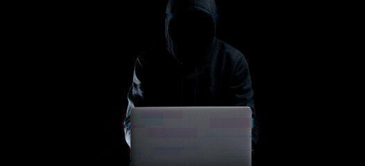 Hacker attack cyber security. Digital laptop in hacker man hand isolated on black. Blurred Internet...