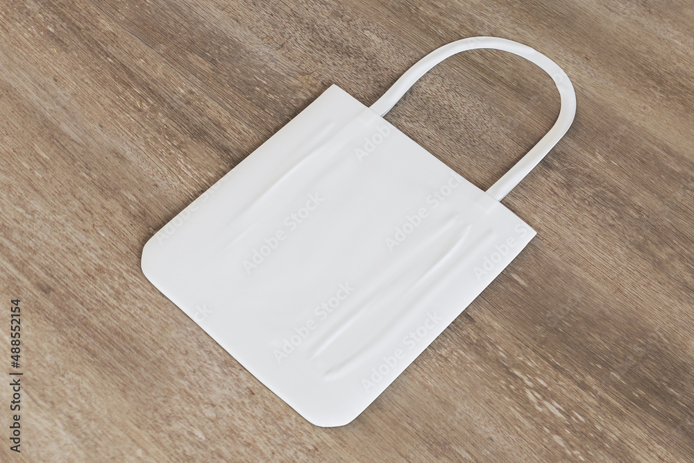 Poster reasonable consumption concept with blank white natural fabric shopping bag on wooden backdrop. 3d r