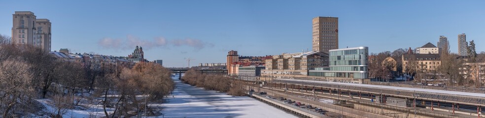 Panorama, water front buildings, iicy canal Karlbergskanalen, traffic route Karlbergsleden, train...