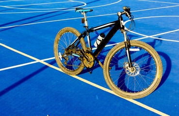 black city bicycle on the sports ground stands