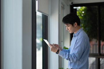 Business asian male using digital tablet for marketing analysis in boardroom.