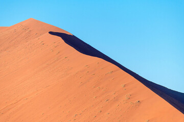 Big natural duna in the sunny desert on the blue sky background, hot Namibia.