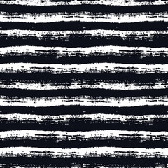 Abstract seamless pattern with paint brush lines. Black and white striped background with grunge stripes. Vector texture.
