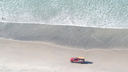 Lifeguard red pickup truck, life guard auto on sand, California ocean beach USA. Rescue pick up car...