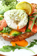 Bruschetta with salmon, avocado, poached egg and white wine