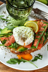 Bruschetta with salmon, avocado, poached egg and white wine