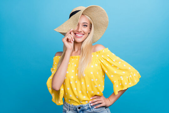 Photo Of Cute Young Blong Lady Hand Hat Wear Yellow Top Cap Isolated On Blue Color Background