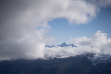 mass of clouds approaching the mountain summits