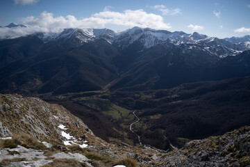 Fototapeta na wymiar snow mountains over a green valley in picos de europa,national park, spain