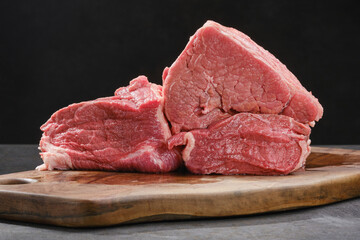 Cut out of raw beef fillet. Raw beef meat on a cutting board. Shallow depth of field