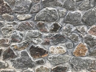 Stone wall. Vintage. Ancient stone laid out on the wall. For background.