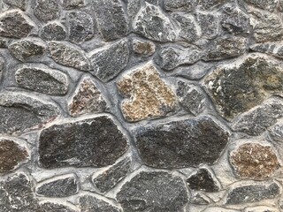 Stone wall. Vintage. Ancient stone laid out on the wall. For background.