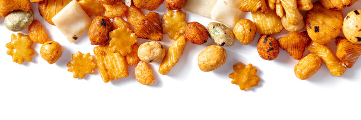 Japanese rice crackers on a white background, panorama, overhead flat lay shot with copy space