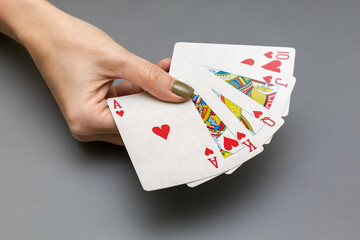female hand holding a selection of poker playing cards