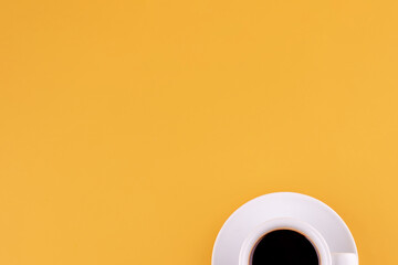 cup of americano coffee on a yellow background. Space for text.