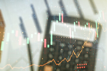 Multi exposure of virtual abstract financial graph hologram and world map on blurry calculator and papers background, financial and trading concept