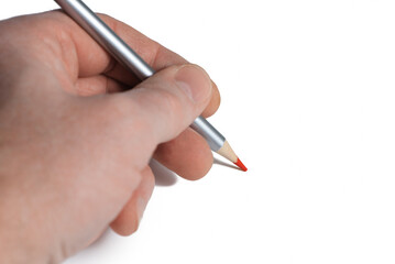 Red pencil in male left hand on blank paper white background. Left hand day concept. Copy space.