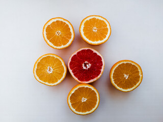 Sliced oranges and grapefruit on a white background flat lay still life