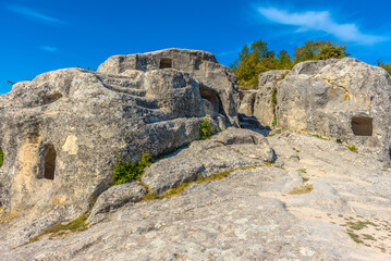 Fototapeta na wymiar Ancient stone caves in a town-fortess Eski-Kermen high in a rocky mountains, Crimea.
