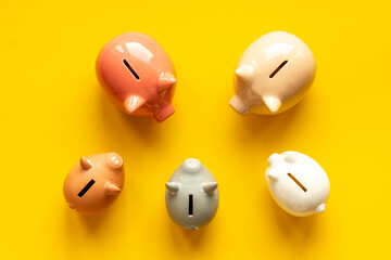 Fototapeta premium Many piggy bank - different types of currency saving and investments