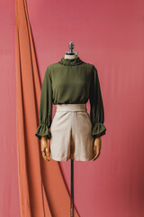 mannequin in a dress on a mannequin red pink background fashion still photography blouse skirt