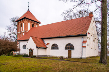 Fototapeta na wymiar Built at the turn of the 16th and 17th centuries from stone and brick in the Baroque style, the Evangelical-Augsburg church in Sorkwity in Masuria, Poland.