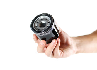 The hand holding the oil filter. Close up. Isolated on white background.