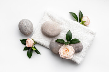 Spa massage stones with white towel. Beauty treatment flatlay