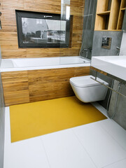 A rubber mat on the floor next to the bathtub in the bathroom. Interior design, modern bath - 488566120