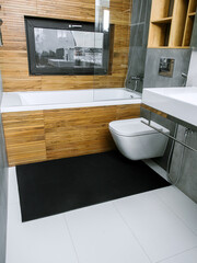 A rubber mat on the floor next to the bathtub in the bathroom. Interior design, modern bath - 488566135