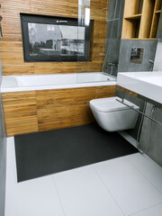 A rubber mat on the floor next to the bathtub in the bathroom. Interior design, modern bath - 488566138