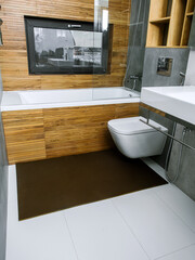 A rubber mat on the floor next to the bathtub in the bathroom. Interior design, modern bath - 488566158