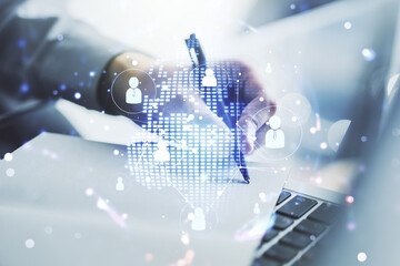 Social network concept with world map and hand writing in notebook on background with laptop....