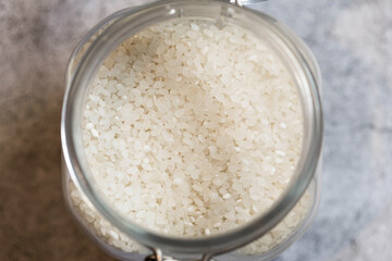 View from above of open glass jar with rice