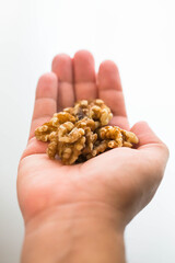 Handful of shelled walnuts. Woman's hand with handful