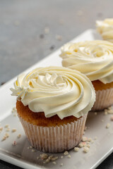 Cupcakes or muffins with cream. Holiday cake celebration, delicious dessert, close up