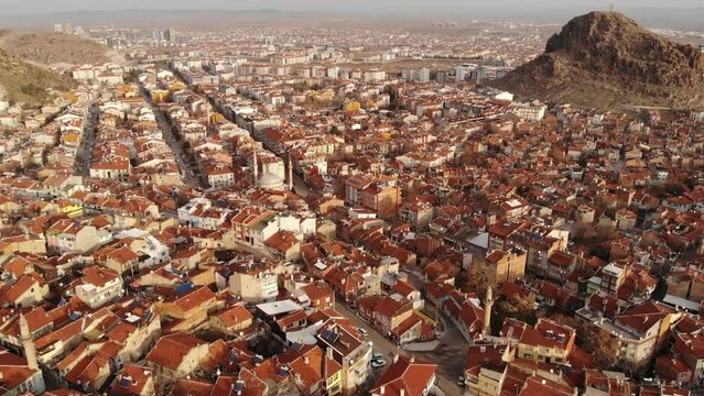 Aerial view of the Turkish landmark fortress of Afyonkarahisar on a rock, located in the middle of residential areas, Turkey.