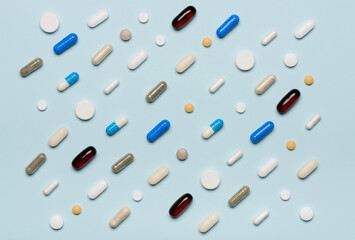 Pills pattern texture on blue background top view flat lay