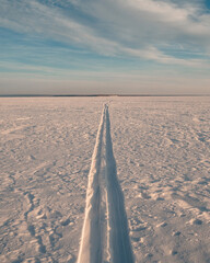 the snowmobile left behind a long strip in the snow	