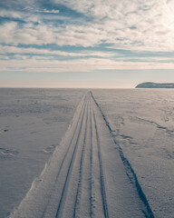 the snowmobile left behind a long strip in the snow	