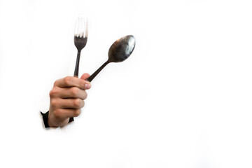 Fork and spoon in hand isolated on white background