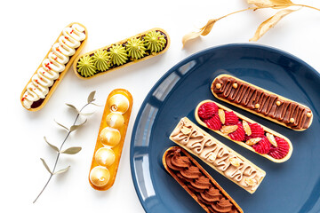 Set of french dessert eclairs with colorful topping