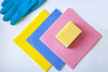 cleaning rugs and glove-colorful sponges, rubber gloves for cleaning on a white background, flat lay.