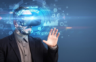 Businessman looking through VR glasses