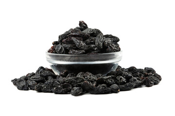 Dark dried raisins in a plate isolated on a white background.
