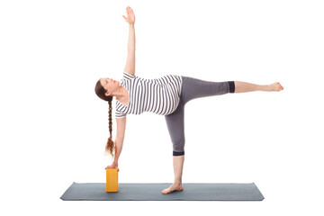 Pregnancy yoga exercise - pregnant woman doing asana virabhadrasana 3 - warrior pose variation with...