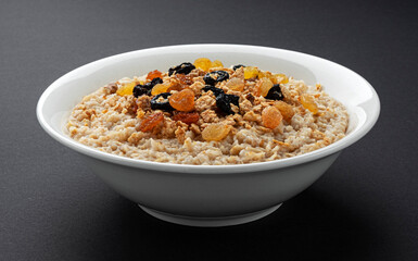 Bowl of oatmeal on black background 