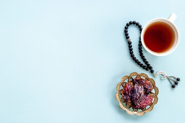 Ramadan Kareem background. Islamic rosary and dates fruits with tea