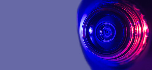 Camera lens with purple and pink backlight. Cyberpunk style. Banner